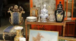 a table topped with a painting next to a chair