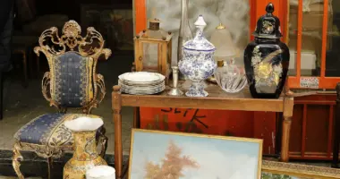a table topped with a painting next to a chair